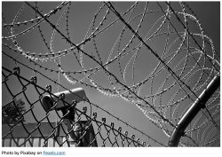 barbed wire and surveillance camera