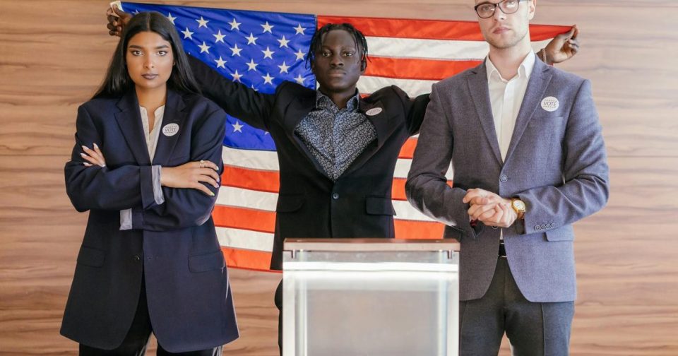 candidate holding American flag behind a lectern